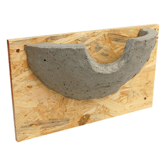 Artificial swallow nest with concrete nesting chamber and plywood backing