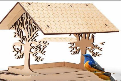 Decorative wooden tree bird feeder with cut-out woodland tree silhouettes and peaked roof in dark carbonized wood - view 2