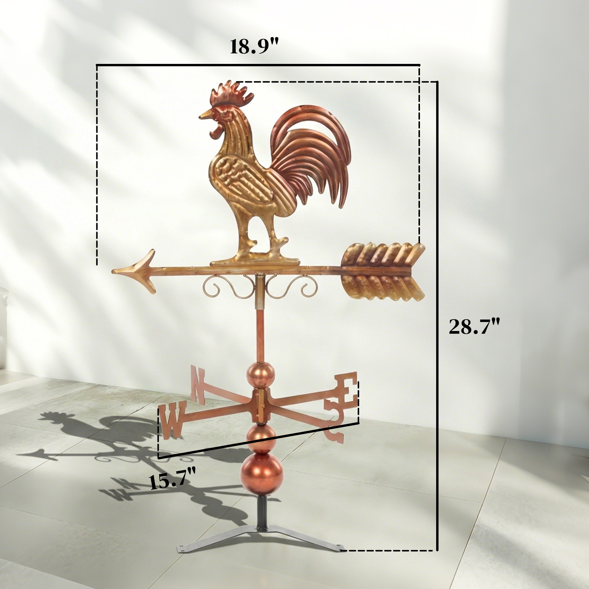 Rustic metal rooster weathervane with red and brown finish and directional arrow in a garden patio - view 4