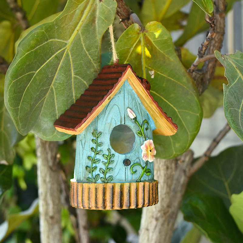 Decorative blue resin hanging birdhouse with floral design